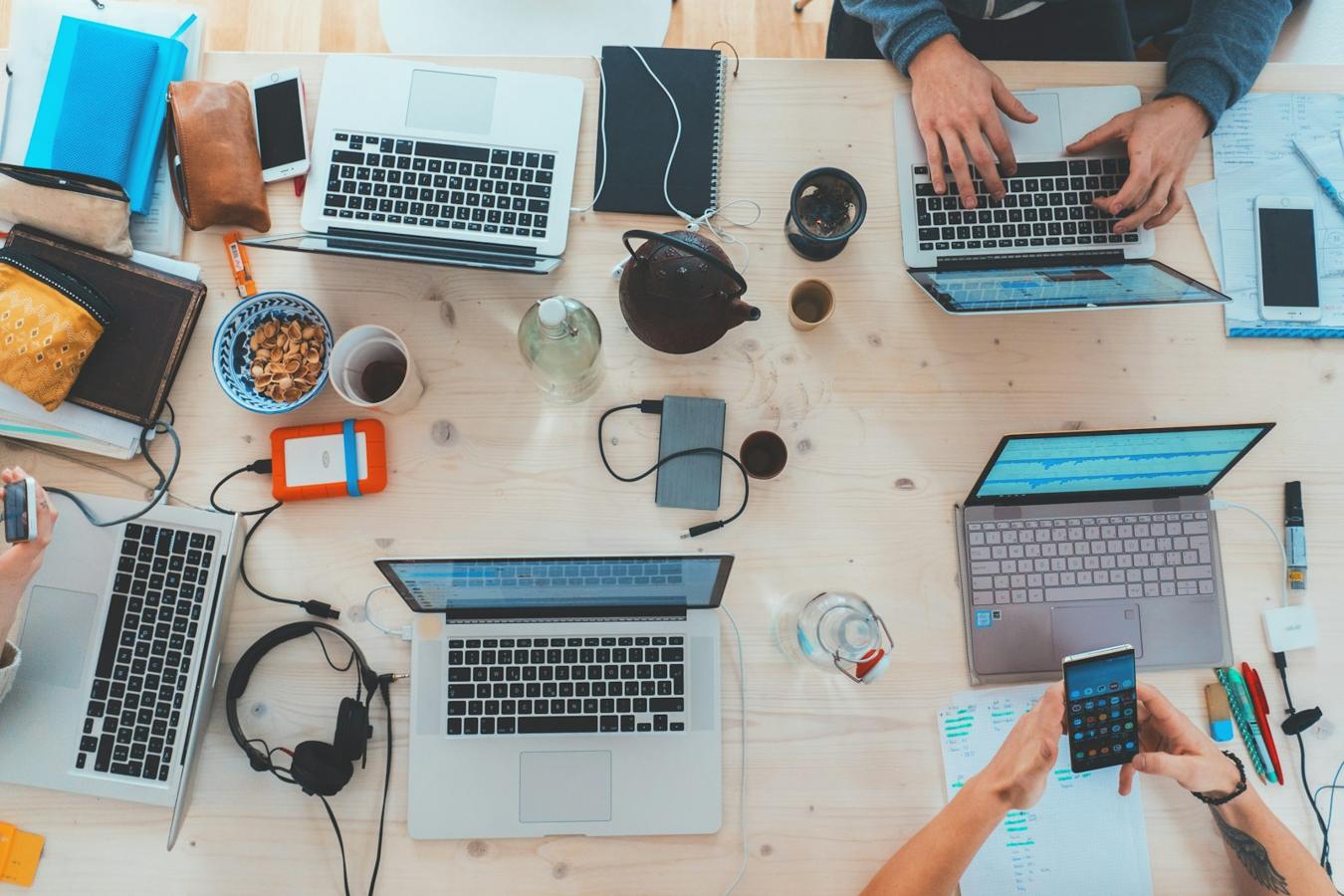 People working on laptops around an office table